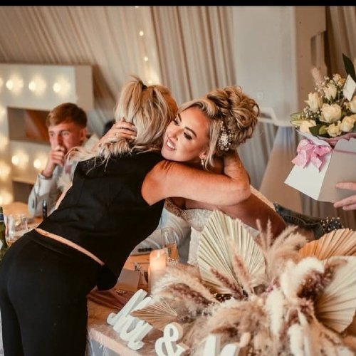 Bride hugging wedding coordinator Bride hugging wedding coordinator
